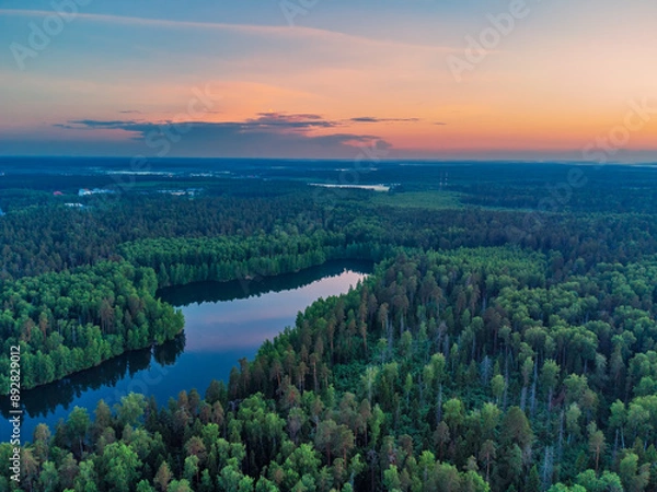 Fototapeta Panorama view from above of the summer landscape. Red sunset sky, fields and forests, river