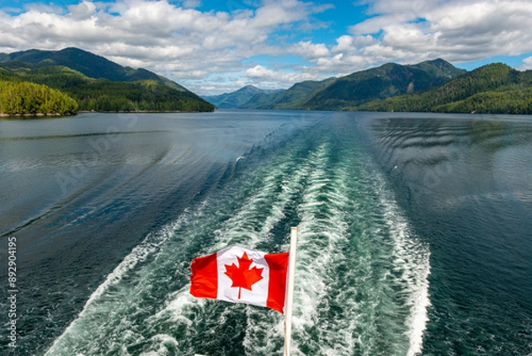 Fototapeta Canadian flag in the back of ferry boat along inside passage cruise, British Columbia, Canada.
