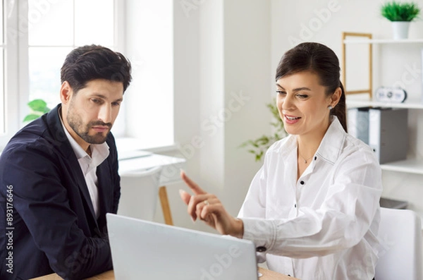 Fototapeta Businessman consulting with beautiful woman tax consultant, close-up. The auditor speaks to the businessman. Concept of tax support for business. Annual report, document verification, cpa