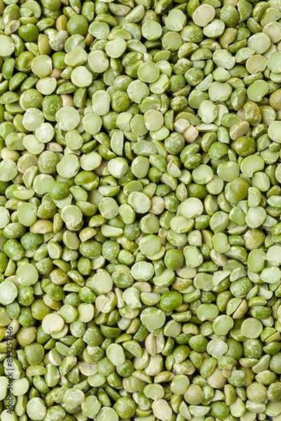 Fototapeta Uncooked, split, green peas background. Dry peas grains. Top view