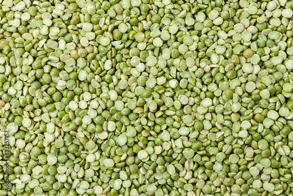 Fototapeta Uncooked, split, green peas background. Dry peas grains. Top view