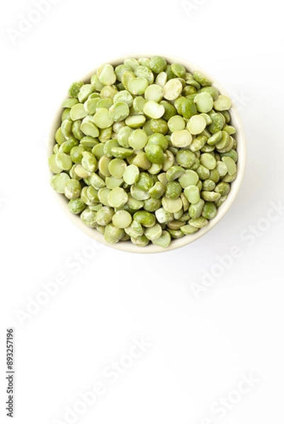 Fototapeta Uncooked, green peas in bowl on white background. Top view. Space for a text