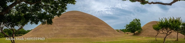 Fototapeta Panoramic view of the man-made hilly landscape formed by the Silla-period tomb mounds Gyeongju, North Gyeongsang, South Korea.