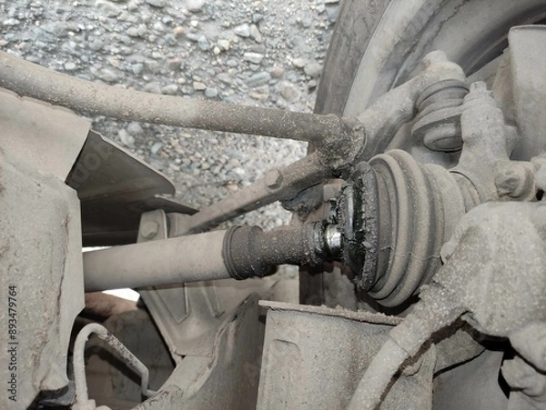 Obraz Broken CV joint on the car. CV joint casing burst and lubricant flows.