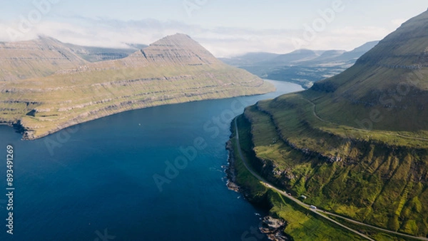 Fototapeta Funningur village, Faroe Islands. Sunny day in summer. Amazing nature in Faroe Islands. Eysturoy Island. Gonguturur or Hvithamar Trailhead. Faroese fjord and summits