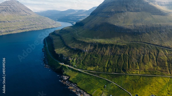Fototapeta Funningur village, Faroe Islands. Sunny day in summer. Amazing nature in Faroe Islands. Eysturoy Island. Gonguturur or Hvithamar Trailhead. Faroese fjord and summits