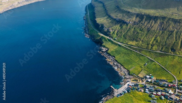 Fototapeta Funningur village, Faroe Islands. Sunny day in summer. Amazing nature in Faroe Islands. Eysturoy Island. Gonguturur or Hvithamar Trailhead. Faroese fjord and summits