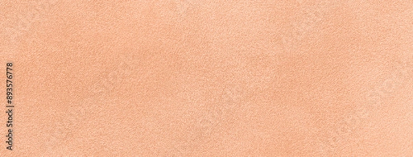 Fototapeta Color year 2024 peach fuzz. Light coral matte background suede fabric. Velvet texture of textile,