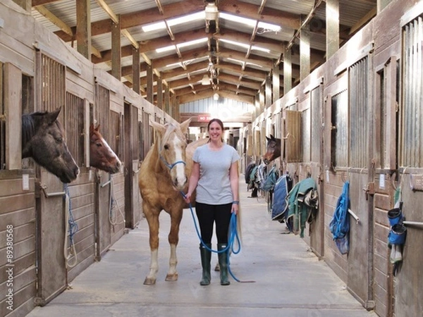 Obraz Zwierzęta: Koń Palomino w stodole z właścicielką