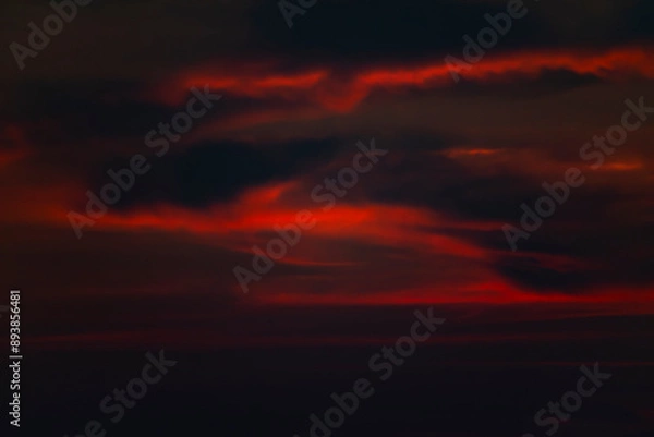 Fototapeta Dramatic fiery red clouds in the sky