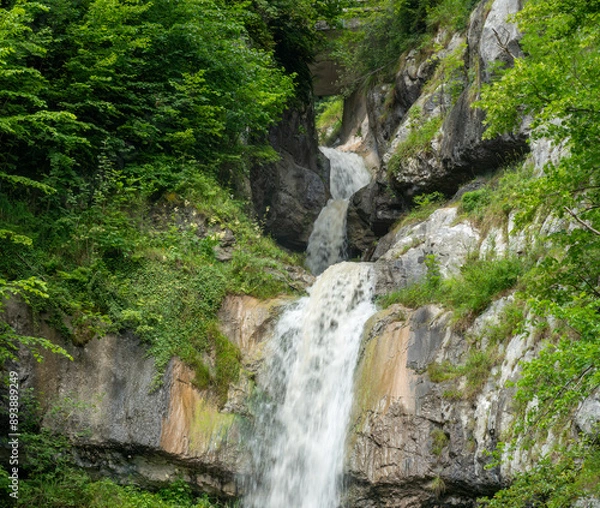 Fototapeta Waterfall emerging from a cave in the mountain,  Hallstatt, Salzkammergut, Upper Austria