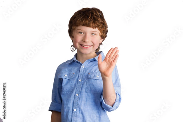 Fototapeta Handsome smiling boy waving with his hand. Isolated on white