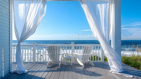 Fototapeta Coastal beachside deck with white Adirondack chairs, flowing sheer curtains, and the sound of crashing waves under a clear blue sky