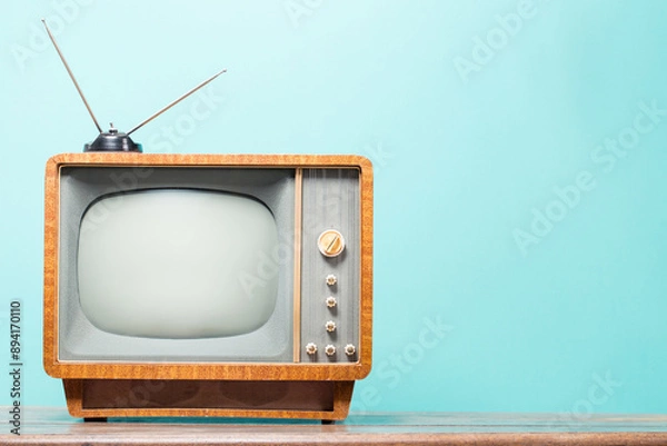 Obraz Old television with wooden body, vintage antenna on table front gradient mint blue background. Retro style filtered photo