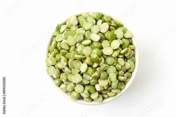 Fototapeta Uncooked, green peas in bowl on white background. Top view