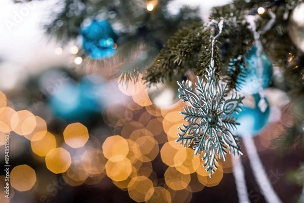 Fototapeta Beautiful festive snowflake decoration on the Christmas tree. Close-up. Beautiful Christmas background. The concept of decorations and decor for the new year. New Year's Card 2025