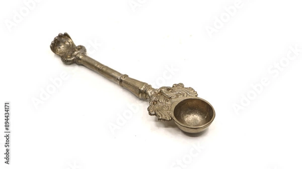Fototapeta antique handcrafted bronze spoon used for pooja rituals isolated on white background