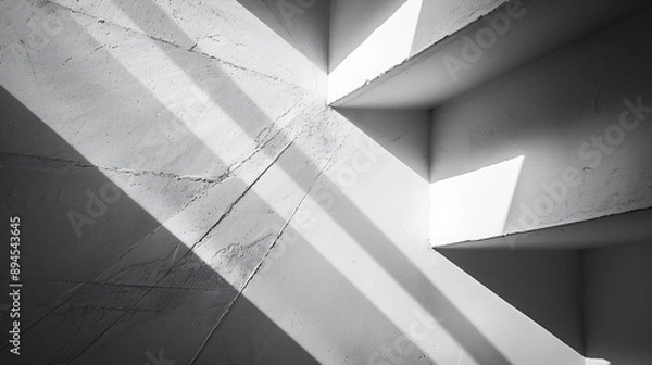 Obraz 光と影が白い壁に幾何学的な形を作り出している、モノクロ写真アート風背景グラフィック