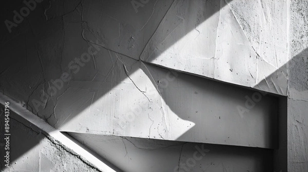 Obraz 光と影が白い壁に幾何学的な形を作り出している、モノクロ写真アート風背景グラフィック
