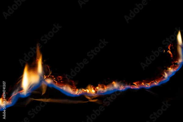Fototapeta burning paper, glowing edge of paper on a black background.