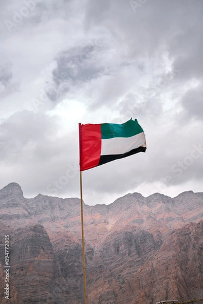 Obraz flag waving in the wind in UAE mountains