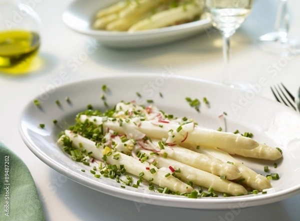 Fototapeta Asparagus with radish and egg vinaigrette on a platter
