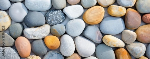 Fototapeta Colorful smooth stones arranged in a beautiful natural pattern for versatile backgrounds