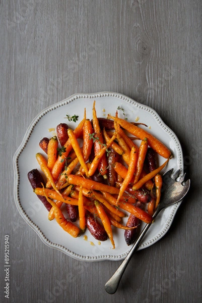 Obraz A large platter serving dish of glazed and roasted carrots with fresh thyme and honey