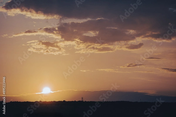 Obraz orange sunset in the clouds over the forest