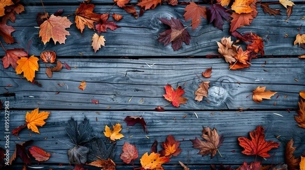 Fototapeta The view from above of autumn leaves with a wooden background.