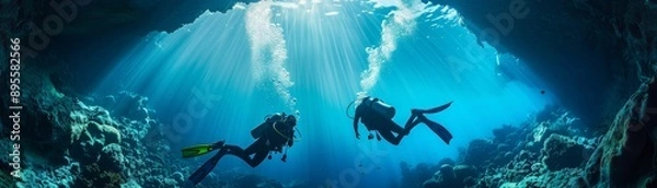 Fototapeta Two scuba divers are swimming in the ocean