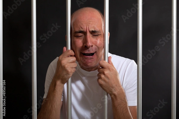 Fototapeta Desperate man in jail