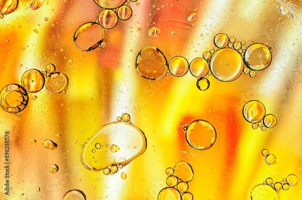 Fototapeta Abstract yellow background with oil, water and bubbles