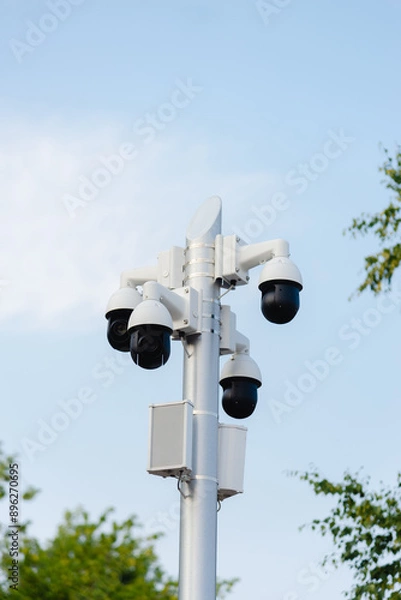 Fototapeta There are many CCTV cameras on a pole in the park.