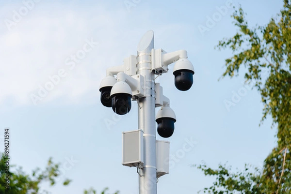Fototapeta Security systems and alarm technology concept: Many CCTV cameras hanging on an outdoor pole and recording. Digital surveillance. High safety and protection cam and video.