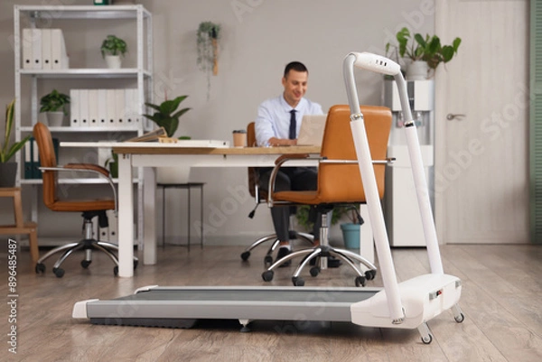Fototapeta Modern treadmill of working businessman in office