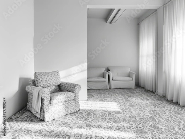 Fototapeta Bare and minimalistic living space with a sofa and chair facing each other.