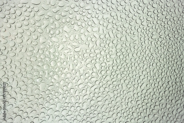 Obraz Abstract image of waterdrops viewed from beneath glass car roof, many water droplets in circular pattern, texture