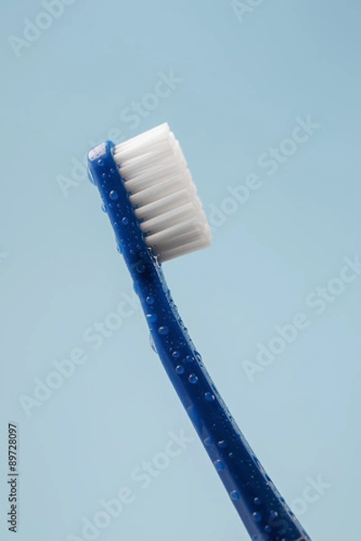 Obraz Blue toothbrush covered with water drops