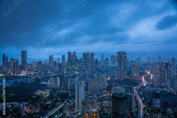 Fototapeta Monsoon Twilight in Midtown Mumbai - View from Byculla with city lights and cloudy blue skies.
