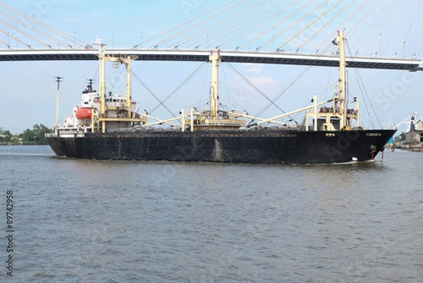 Obraz Cargo ship pass under the bridge