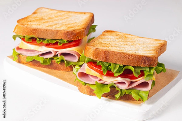Obraz Club sandwich with ham, cheese, tomato and lettuce. 