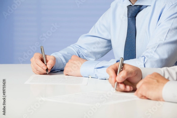 Obraz Unrecognizable businessmen signing a contract