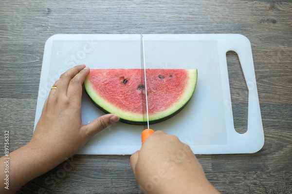 Fototapeta Cutting a watermelon