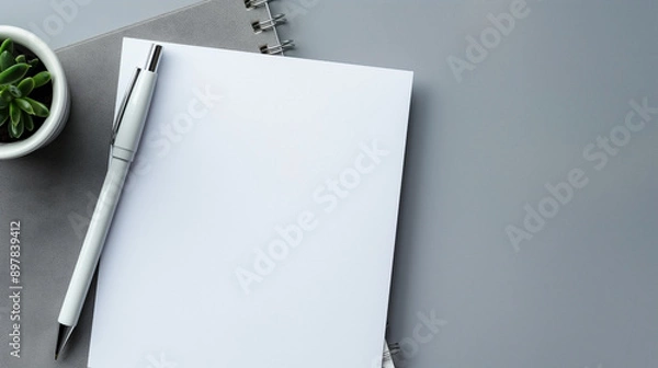 Fototapeta White paper and pen on gray background with space for text top down view of work area.