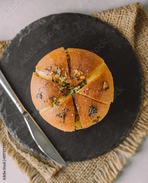 Obraz a slice of garlic bread on a rectangular plate