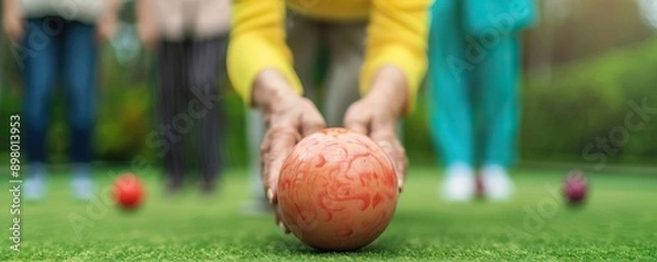 Fototapeta Elderly group enjoying a game of lawn bowls, bright and lively atmosphere, fun physical activity, wellness concept, empty copy space on the right