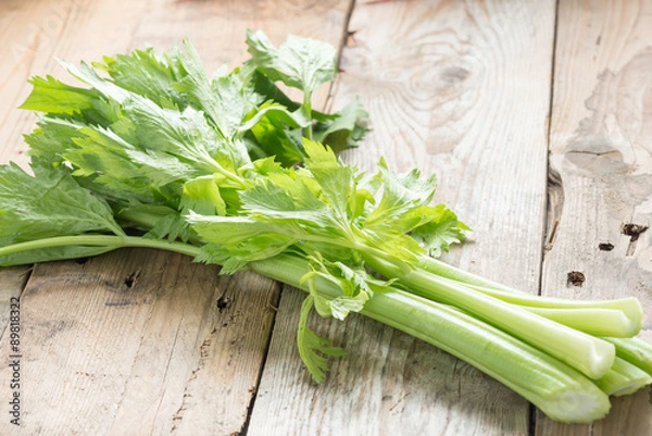 Obraz Fresh celery on wood background.