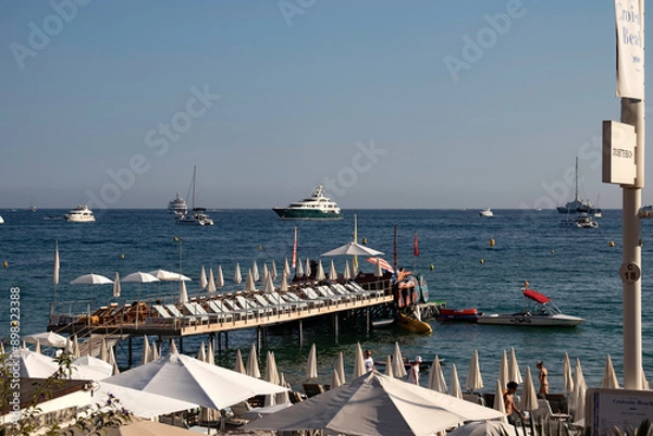 Fototapeta A jetty over the sea and yachts on the water at the beach on La Croisette in Cannes in the wouth of France