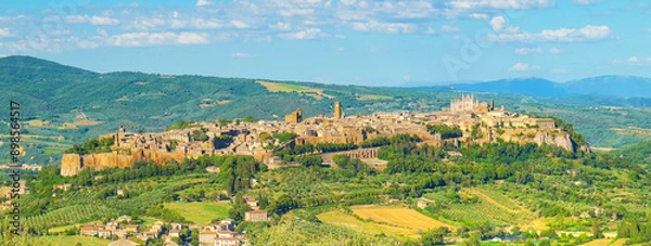 Fototapeta Orvieto, Italy. Afternoon view of Orvieto and its historic center. Countryside and hills surround the old Etruscan city in the province of Terni, Umbria. Banner header image. 2024-06-22.